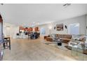 The home's expansive living area, featuring neutral tones and a tile floor, is ideal for entertaining at 2613 Velodrome Ct, Henderson, NV 89044