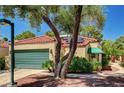 Inviting single-story house with a two-car garage, desert landscaping, and a red tile roof at 2832 Cape Hope Way, Las Vegas, NV 89121