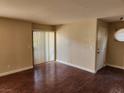 Cozy living room featuring wood-look floors, neutral paint, and sliding glass doors at 2974 Juniper Hills Blvd # 104, Las Vegas, NV 89142