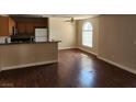 Open concept living room with modern, wood-look floors, and access to kitchen at 2974 Juniper Hills Blvd # 104, Las Vegas, NV 89142