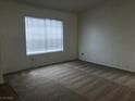 Bright bedroom featuring neutral carpeting, and a large window at 3138 White Rose Way, Henderson, NV 89014