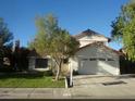 Charming home featuring a spacious driveway and well-manicured lawn at 3138 White Rose Way, Henderson, NV 89014