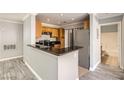 The kitchen features wood cabinets, a breakfast bar, and granite countertops at 3150 Soft Breezes Dr # 1050, Las Vegas, NV 89128