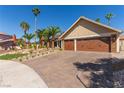 Single-story home with a three-car garage and beautiful desert landscaping at 326 Fuente Dr, Henderson, NV 89014