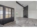 Bright living room features high ceilings, a modern fireplace, and sleek flooring at 326 Fuente Dr, Henderson, NV 89014