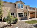 A fully fenced backyard with a covered patio, a balcony, and low-maintenance landscaping at 3624 Pelican Brief Ln, North Las Vegas, NV 89084