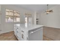 Kitchen island featuring white cabinets, drawers, and a quartz countertop at 3713 Nairobi Ln, North Las Vegas, NV 89032
