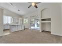 Bright living space with carpet, open to kitchen with island and sliding glass door at 3713 Nairobi Ln, North Las Vegas, NV 89032