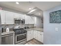 Image of kitchen with stainless appliances, granite, white cabinets at 4078 Gold Coast Dr, Las Vegas, NV 89121