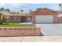 Single-story home with a spacious driveway, two-car garage, and well-maintained artificial lawn at 4115 Ridgewood Ave, Las Vegas, NV 89120