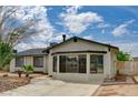Charming single-story home showcasing a well-maintained yard, a concrete driveway and new exterior paint at 4387 Sun Vista Dr, Las Vegas, NV 89104