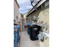 Functional side yard with trash bins and secured gate, offering practical outdoor space at 4568 Little Finch Ln, Las Vegas, NV 89115