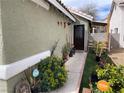 Inviting home exterior with manicured garden, featuring vibrant plants and smart home security at 4568 Little Finch Ln, Las Vegas, NV 89115