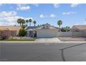 Charming single-story home with palm trees, desert landscaping, and white exterior at 4644 Canna Dr, Las Vegas, NV 89122