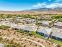 An aerial view captures the neighborhood's layout, mountain backdrop, and desert surroundings at 4893 E Cedar Creek Way, Pahrump, NV 89061