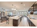Bright, open kitchen with a large center island, modern lighting, and stainless appliances at 4893 E Cedar Creek Way, Pahrump, NV 89061