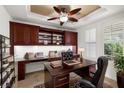 Well-lit office featuring custom built-ins, a large desk, and plantation shutters for a professional and comfortable workspace at 5067 Pensier St, Las Vegas, NV 89135
