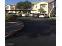 A parking lot in front of an apartment building with covered parking at 5655 E Sahara Ave # 1037, Las Vegas, NV 89142