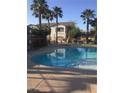 A community swimming pool with a staircase and palm trees at 5655 E Sahara Ave # 1037, Las Vegas, NV 89142