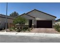 Charming single-story home with a well-maintained front yard and a brick-paved driveway and front walkway at 6009 La Coste St, North Las Vegas, NV 89081