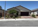 Charming single-story home with a well-maintained front yard and a brick-paved driveway and front walkway at 6009 La Coste St, North Las Vegas, NV 89081