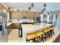 Spacious kitchen featuring a large island with seating, stainless steel appliances, and modern cabinetry at 6009 La Coste St, North Las Vegas, NV 89081