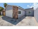 Single Gathering home with stone accent, attached garage, and concrete driveway at 6017 Natures Dr, Las Vegas, NV 89122