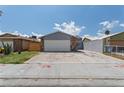 Charming single-story home with a two-car garage and spacious concrete driveway at 6017 Natures Dr, Las Vegas, NV 89122