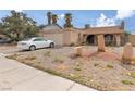 Quaint single-Gathering home with a gravel yard, car in the driveway, and desert landscaping at 604 N Torrey Pines Dr, Las Vegas, NV 89107