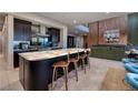 Modern kitchen features a large island with seating and stainless steel appliances, with an open floorplan at 609 Sleeping Dragon Dr, Henderson, NV 89012