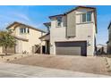 Two-story home featuring a two car garage, desert landscaping, and brick-paved driveway in a suburban neighborhood at 6618 Palm Branch St, North Las Vegas, NV 89086