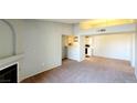 Spacious living room with neutral carpet, and a view of the kitchen and adjacent dining area at 7885 W Flamingo Rd # 2003, Las Vegas, NV 89147