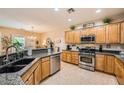 Well-lit kitchen features granite countertops, stainless steel appliances, and wood cabinetry at , Henderson, NV 89044