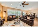 Spacious living room with plantation shutters, tile flooring, ceiling fan, and comfortable seating at , Henderson, NV 89044