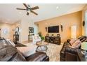 Cozy living room with comfortable leather sofas, ceiling fan, recessed lighting, and stylish decor at , Henderson, NV 89044