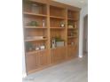 Large built-in shelving unit with storage and decorative items at 1006 Cove Palisades Dr, North Las Vegas, NV 89031