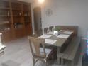 Dining room with a large table, six chairs, and a large built-in bookcase at 1006 Cove Palisades Dr, North Las Vegas, NV 89031