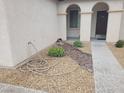 Close-up view of the home's entry way, enhanced by desert landscaping and a covered porch at 1006 Cove Palisades Dr, North Las Vegas, NV 89031