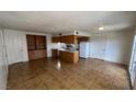 Spacious open-concept living area with tile flooring that flows into the kitchen area at 101 Luna Way # 145, Las Vegas, NV 89145