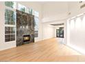Bright, airy living room featuring high ceilings, a marble fireplace, and large windows with a backyard view at 10668 Porta Romana Ct, Las Vegas, NV 89141