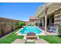 Inviting backyard pool and spa area featuring a fire pit and lush landscaping for relaxation and enjoyment at 1081 Via Gandalfi, Henderson, NV 89011