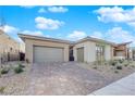 Beautiful exterior showing a three-car garage and modern landscaping with a stone driveway at 11049 Concord Valley Drive, Las Vegas, NV 89135