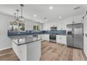 Bright kitchen featuring granite countertops, stainless steel appliances, a breakfast bar, and blue backsplash at 1109 Maserati Dr, Las Vegas, NV 89117