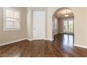 Elegant foyer featuring hardwood floors, an arched doorway, and a bright, welcoming atmosphere at 11228 Hedgemont Ave, Las Vegas, NV 89138