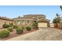 Exterior showcasing a well-maintained lawn, mature landscaping, and a two-car garage at 11278 Tenza Ct, Las Vegas, NV 89141