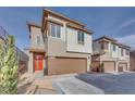 Beautiful two-story home featuring an orange door and a two-car garage at 11946 Glide Reflection Ave, Las Vegas, NV 89138