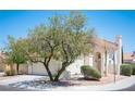 Charming two-story home featuring a well-maintained lawn, stucco, and large shade tree at 1620 Western Lily St, Las Vegas, NV 89128