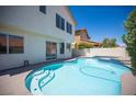 Inviting backyard pool with a step-in entrance and a patio for outdoor entertaining at 1620 Western Lily St, Las Vegas, NV 89128