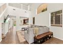 Bright living room featuring high ceilings, an oversized sofa, tile floors and lots of natural light at 1887 Hollywell St, Las Vegas, NV 89135
