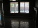 Living room with tile flooring and large windows with adjustable blinds at 1927 Raspberry Hill Rd, Las Vegas, NV 89142